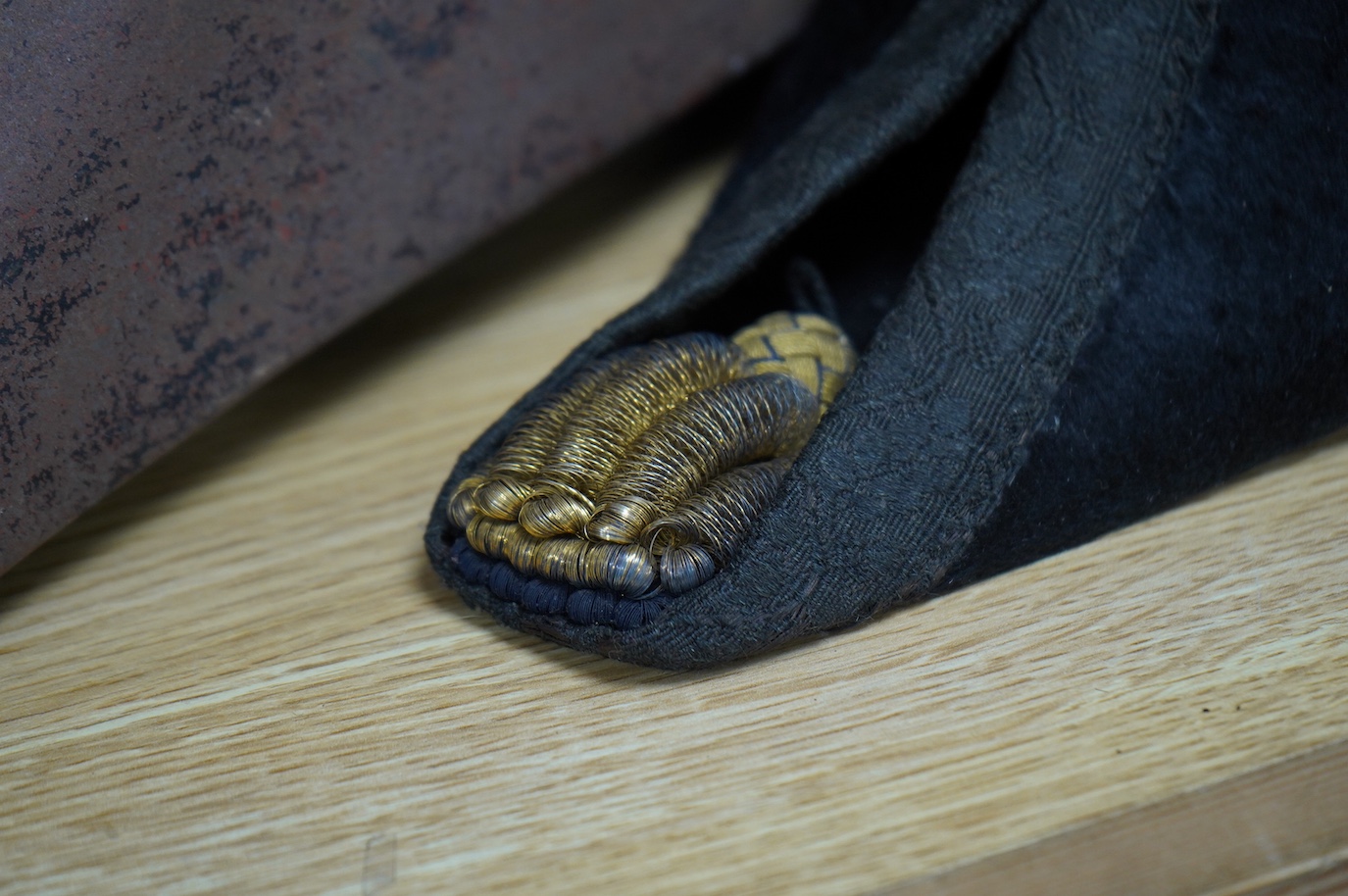 A Naval Lieutenant's bi-corn hat, in its tin case, with applied plaque for D. Donavon R.N. Condition - fair, with general surface rust to the case.